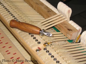 Grand piano action, voicing the hammers